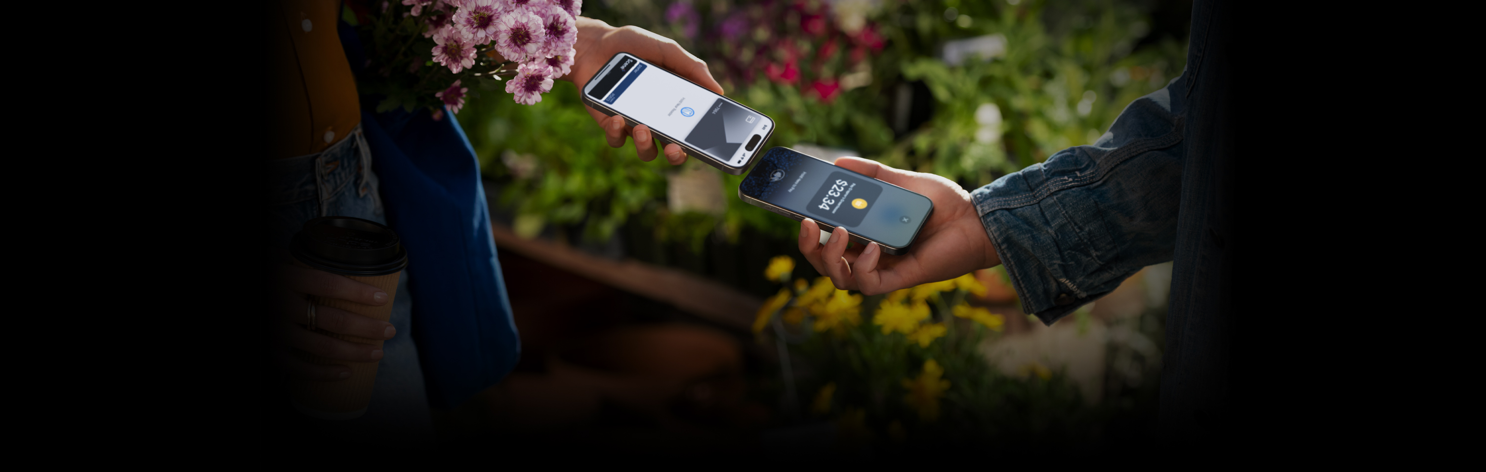 An image of two people holding their iPhone devices together completing a transaction.