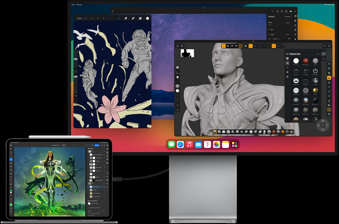 Magic Keyboard’a takılı, yatay pozisyonda iPad Pro, harici ekrana bağlı, her iki ekranda da görseller düzenleniyor