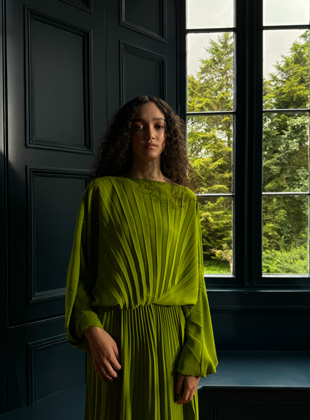 A photo shot in 28 mm of a woman in a green dress