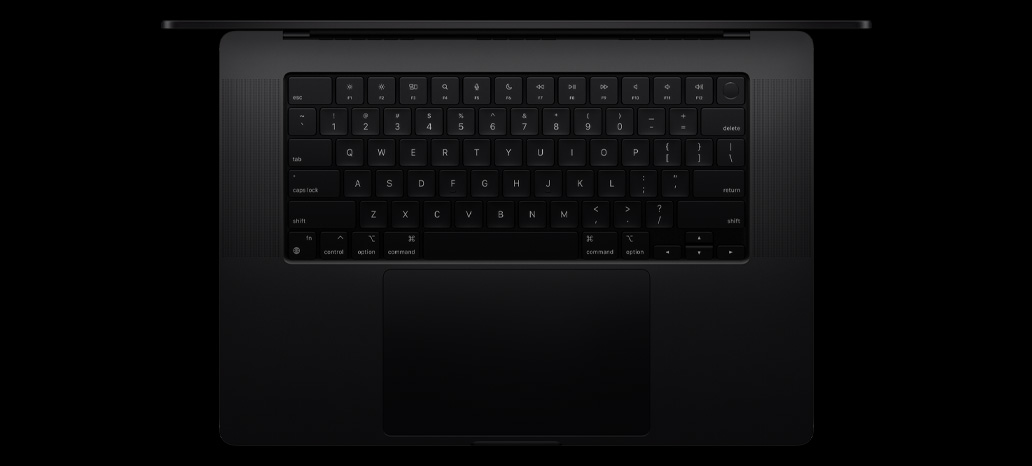 Top-down view of MacBook Pro shows built-in Magic Keyboard with Touch ID and trackpad